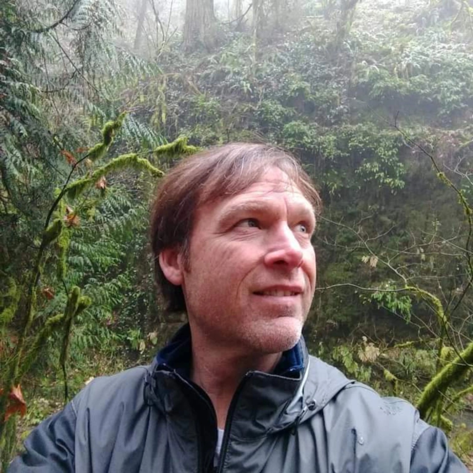 Artist and author Stefan Senna outdoors in a forest